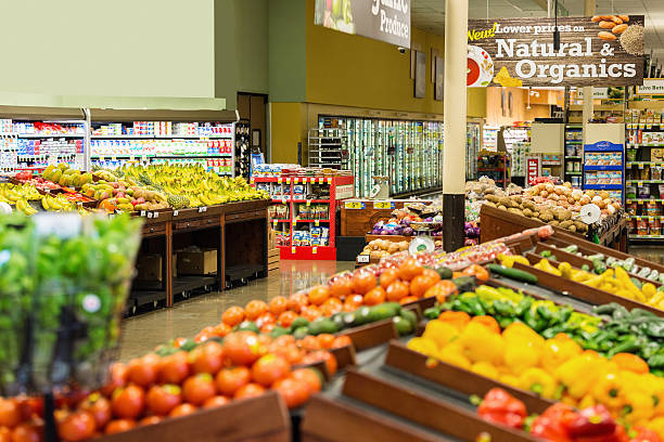 Colorful fresh fruit and vegetables for sale in local supermarket Colorful fresh fruits and vegetables are displayed in produce section of local grocery store or supermarket. Rows of tomatoes, peppers, potatoes, bananas, apples, and other natural organic produce is arranged on shelves and tables. produce section stock pictures, royalty-free photos & images