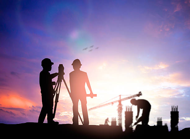 istock silhouette survey engineer working  in a building site over Blur 497892956