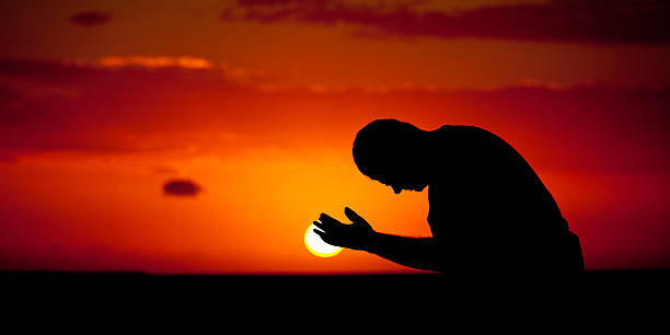 gebet silhouette - praying men god kneeling stock-fotos und bilder