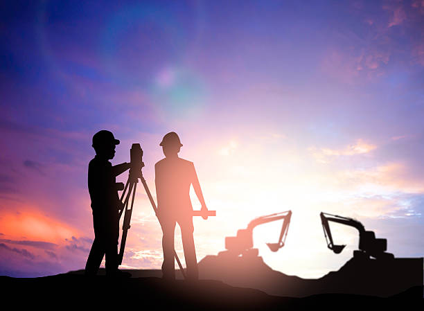 istock silhouette survey engineer working  in a building site over Blur 497893016