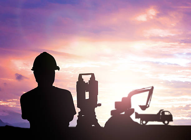 istock silhouette survey engineer working  in a building site over Blur 497893166