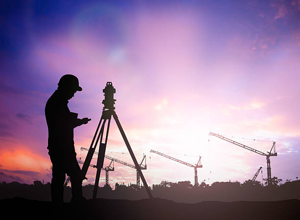 istock silhouette survey engineer working  in a building site over Blur 497893418