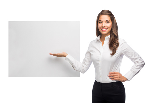 portrait of blonde business woman in formal wear showing empty clipboard on white background
