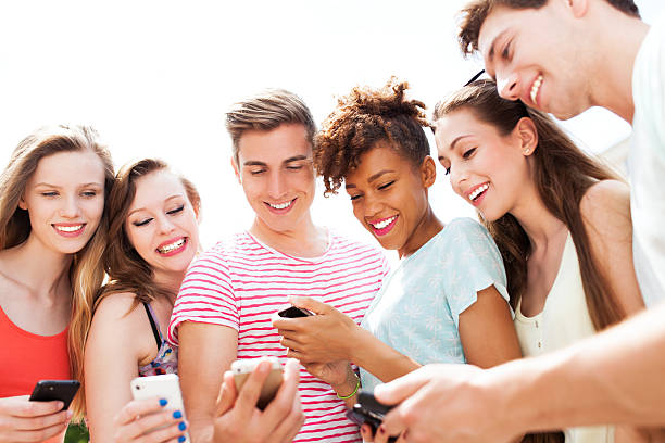 istock Young people looking at smartphones 497895131