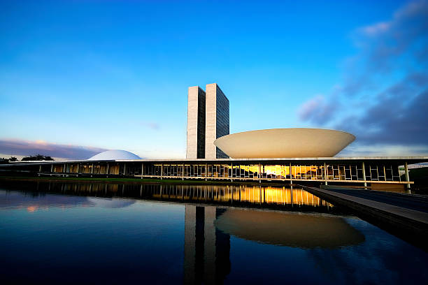Brazilian National Congress at Sunset Brasilia, Federal District, Brazil - May 27, 2007: Brazil's Bicameral National Congress is part of the city's main monuments and was projected by the brazilian architect Oscar Niemeyer. Since the 1960s, the National Congress has been located in Brasília. The semi-sphere on the left represents the Senate, and the semi-sphere on the right is the Chamber of the Deputies. senate photos stock pictures, royalty-free photos & images