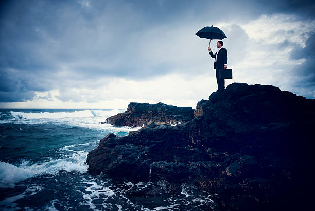 istock Lonely Businessman Standing by the Beach 497895559
