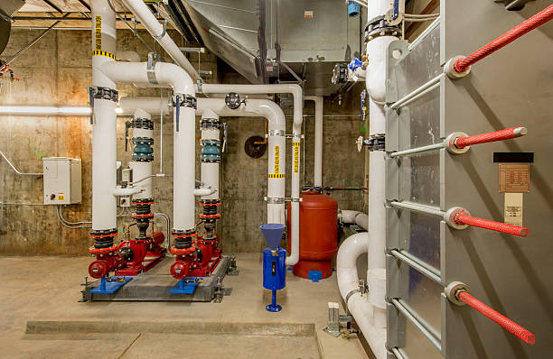 Water Pumps and Heat Exchanger Water pumps and heat exchanger in an HVAC installation. water pump photos stock pictures, royalty-free photos & images
