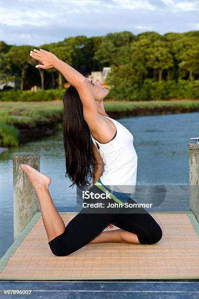 Woman Doing Yoga On A Dock Stock Photo - Download Image Now - 20-29 Years, Adult, Adults Only