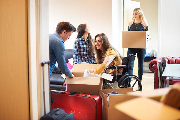 istock student with disability and housemates moving into halls 497899832