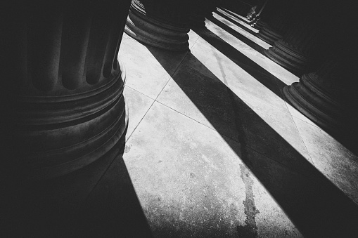 Streams of light and shadows from pillars.
