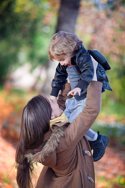 istock Happy mother and son playing in park. 497899956