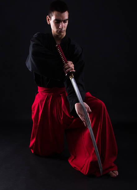 istock Young martial arts fighter with katana 497900628