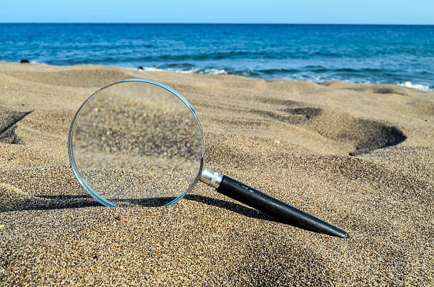 istock Magnify Glass on the Sand Beach 497901056