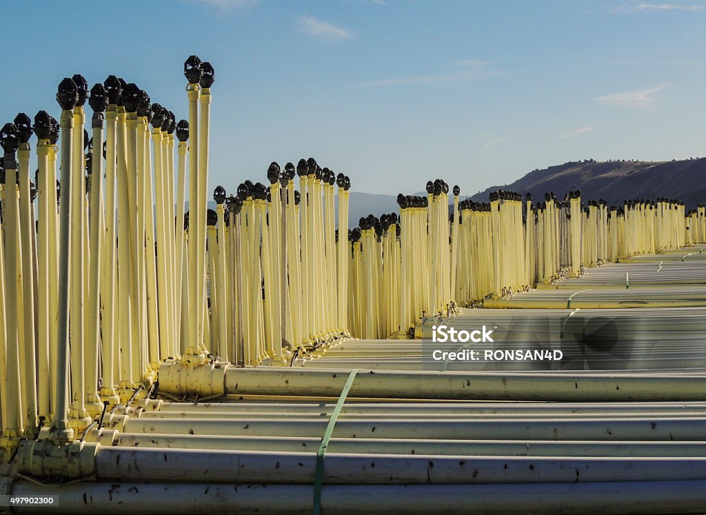 Pipe Agricultural Irrigation pipe stacked for storage, Siskiyou County, Tule Lake, California. Tule Lake national Wildlife Refuge leases land to growers who produce Potatoes, Onions, Alfalfa and cereal grain. 2015 Stock Photo