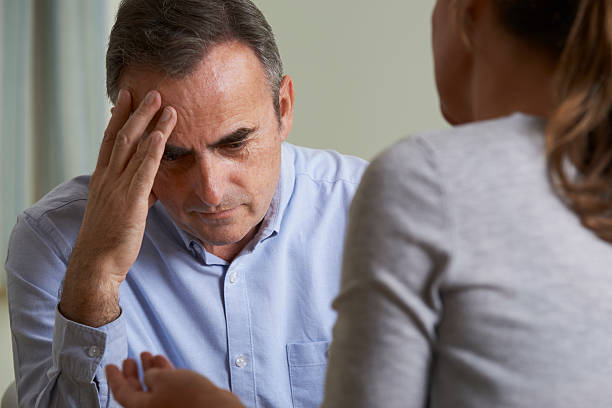istock Depressed Mature Man Talking To Counsellor 497902656