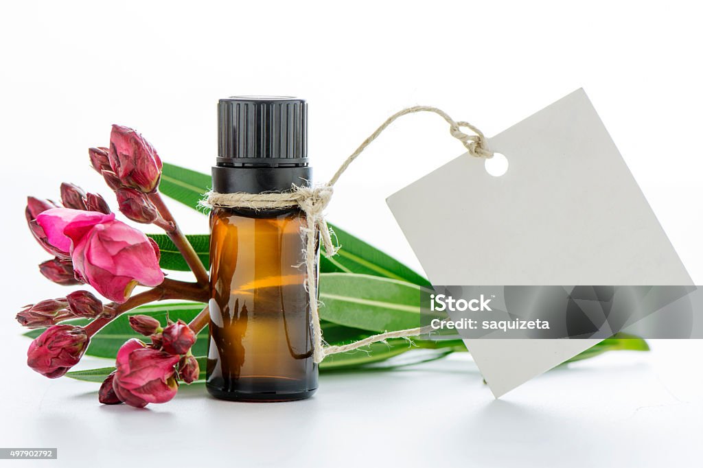 Essential oil, empty tags and roses flowers Essential oil, empty tags and roses flowersEssential oil, empty tags and roses flowers 2015 Stock Photo