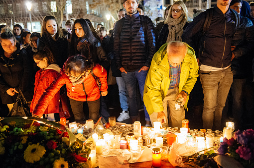 Strasbourg, France - November 18, 2015: People gathering, placing flowers, messages and candles in center of Strasbourg, in solidarity for victims and families of the assault in Paris