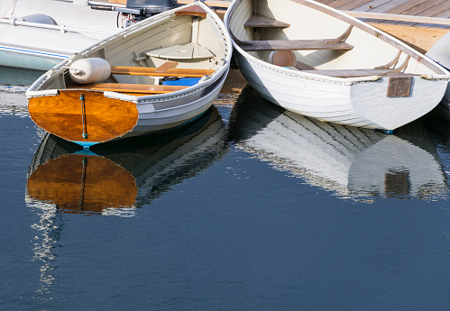 Wooden rowboats at dock in fishing village in Maine.