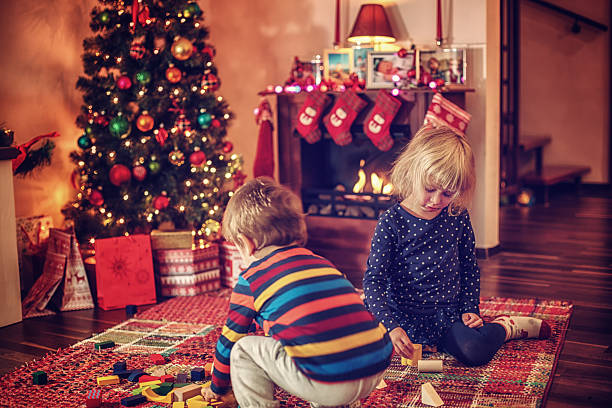 istock Adorable Kids Playing in in front of Christmas Tree 497906656