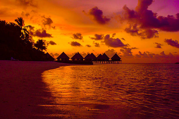 Sunset in the Maldives, Velidhu, North Ari Atolls The Maldives - Sunset over Velidhu in the North Ari Atoll Group water bungalow maldives stock pictures, royalty-free photos & images