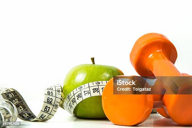 Green Apple Tape Measure And Dumbbells Stock Photo - Download Image Now - 2015, Activity, Aerobics