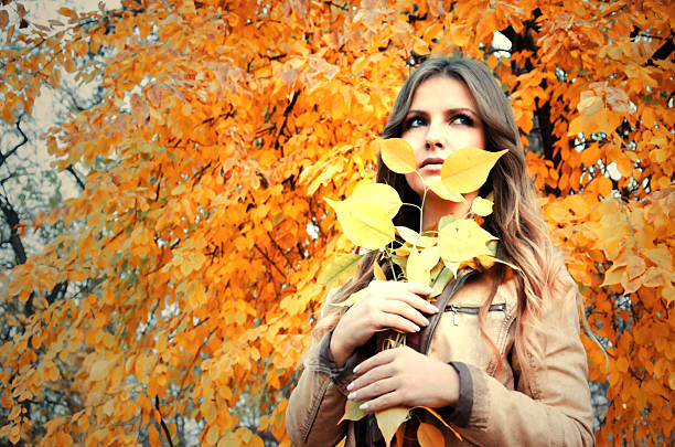 istock beautiful girl enjoys autumn days 497907150