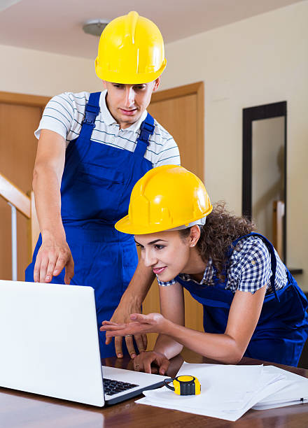 istock team of builders brainstorming and smiling indoors 497938144
