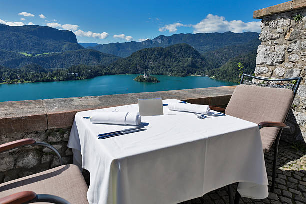 istock Served table with emty plate, lake Bled, island and Alps 497939758