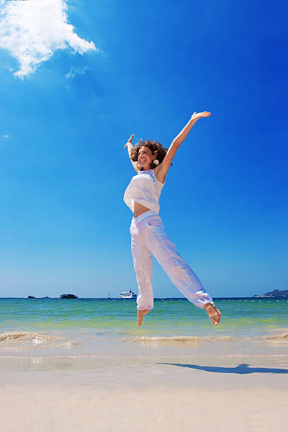 istock girl runs at the sea 497939824