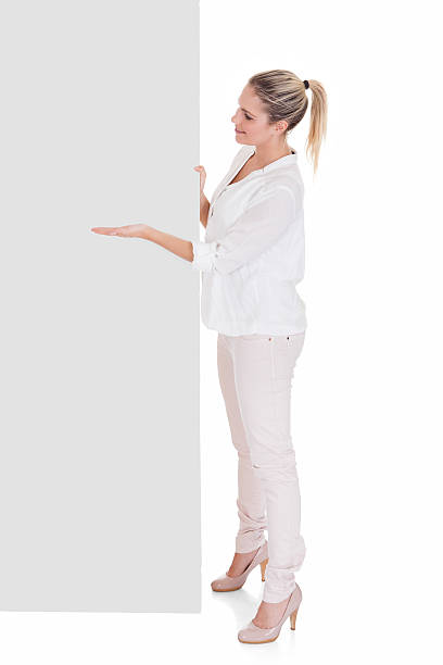 istock Young woman presenting blank placard 497940564