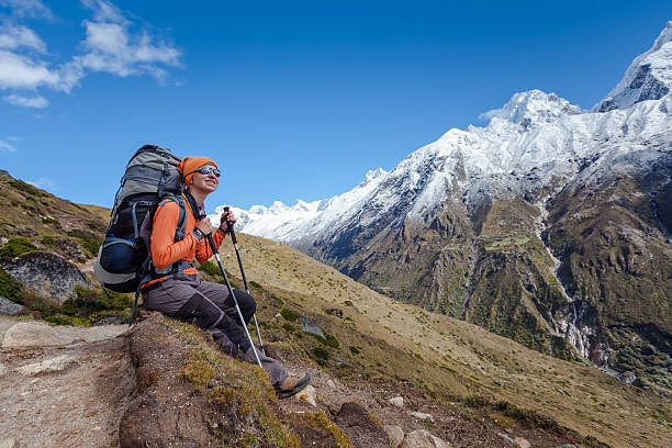 istock Hiker rests on trek in Himalayas, Nepal 497941064