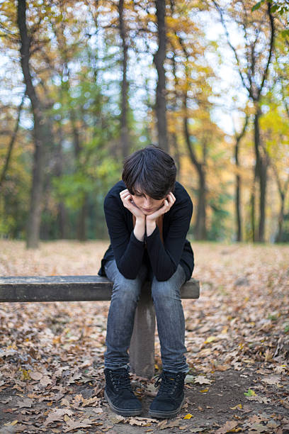 istock Sad girl sitting on a bench 497942302
