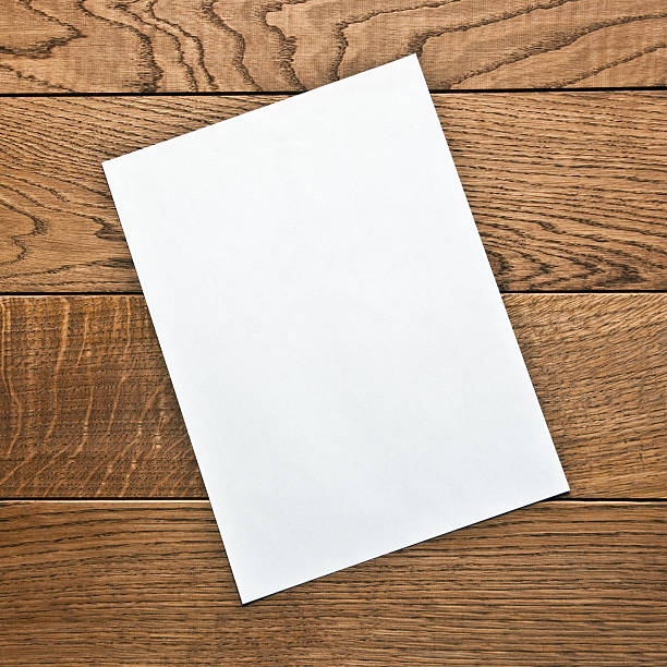 istock blank sheet of paper on a wooden table 497943864