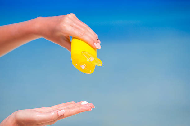 istock Closeup suncream bottle background blue ocean and sky 497944810