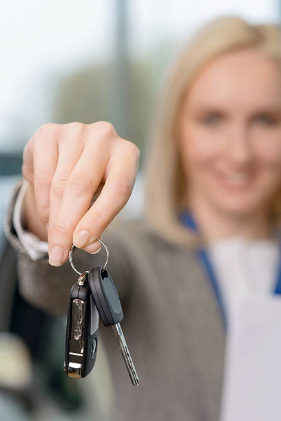 istock Saleswomans hand grasping the car keys 497944976