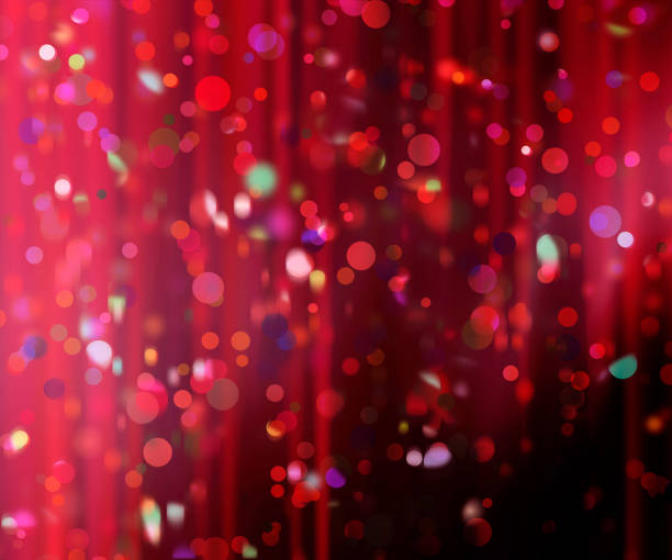 confetti against a blurred curtain background stock photo