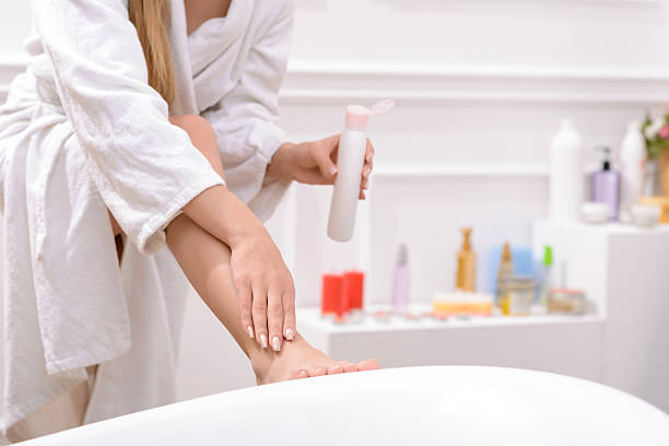 istock Pleasant woman using creme for body 497945260