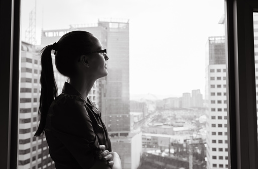 Businesswoman looking out the window.