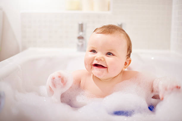istock Baby boy laughing in his bubble filled bath 497947314