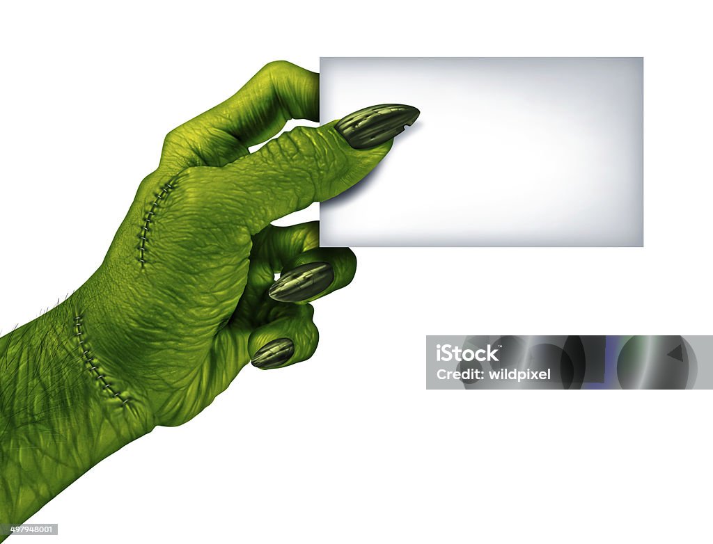 Zombie Blank Card Zombie hand holding a blank card sign on a side view as a creepy halloween or scary symbol with textured green skin wrinkled monster fingers and stitches isolated on a white background.. Halloween Stock Photo