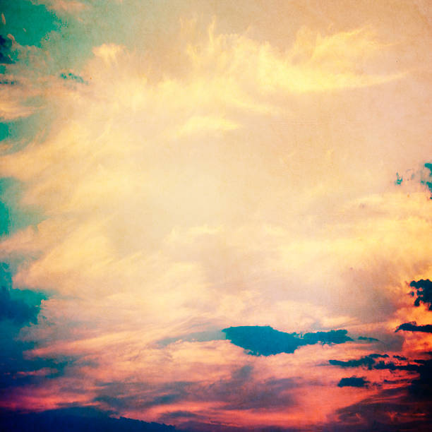 istock clouds on a textured vintage paper background, with grunge stains 497948353