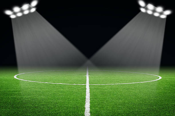 istock Soccer ball on field in stadium at night 497950763