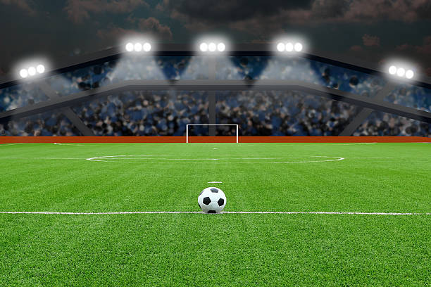 istock Soccer ball on field in stadium at night 497950769