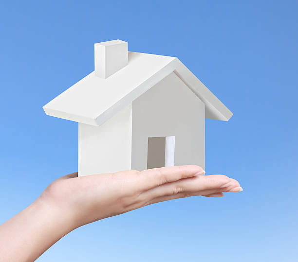 istock holding house representing home ownership 497951373