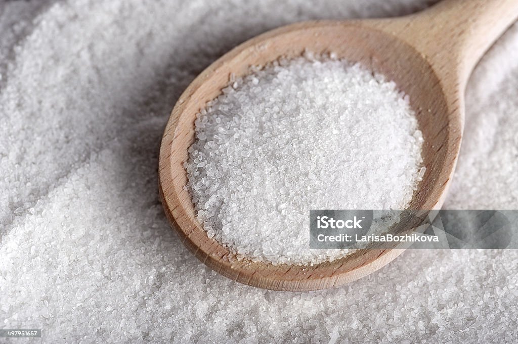 Salt or sugar Salt/sugar on wooden teaspoon Close-up Stock Photo