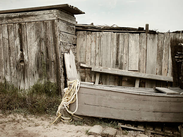 istock Old wooden beach warehouse and boat 497951799