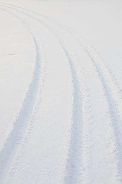 istock Car tire track in snow 497956006