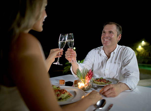 istock Couple making a toast at a romantic dinner 497956562