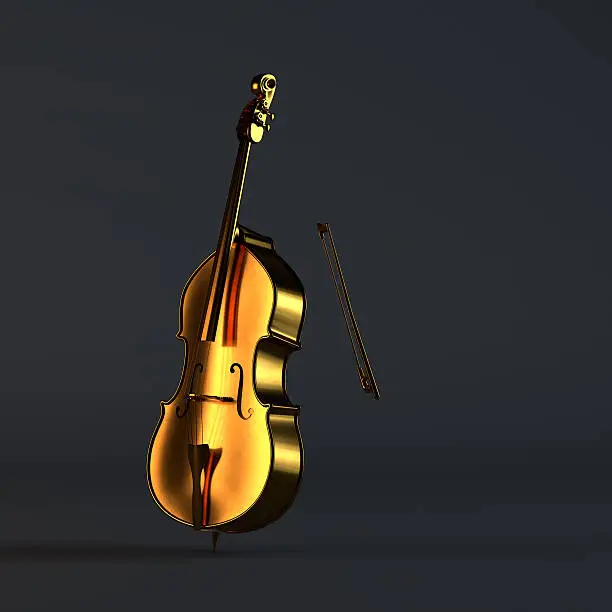 Golden cello standing in a black studio