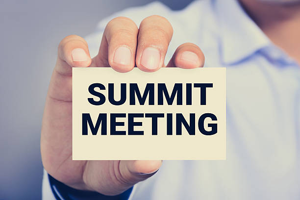 istock SUMMIT MEETING, message on the card shown by a man 497960144